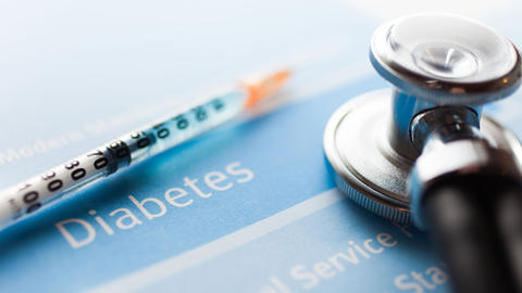Insulin syringe with needle and stethoscope.