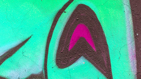 Abstract background image of a fragment of a colored graffiti painting in green tones.