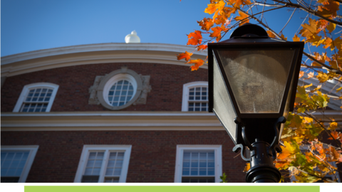 Close-up of lamppost and Harvard brick building.