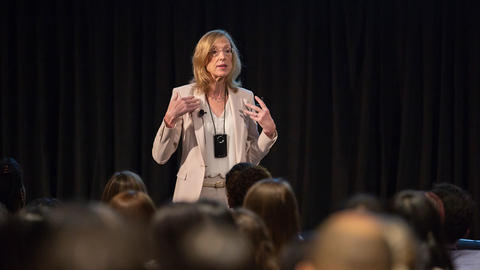 Professor Sue J. Goldie speaking in front of student audience.