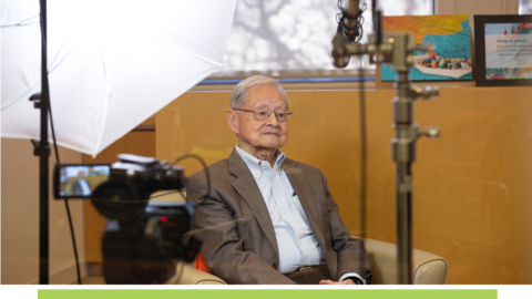 William Hsiao sitting in front of cameras.