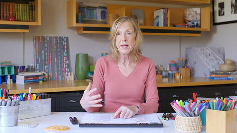 Sue J Goldie sitting in GHELI's studio.