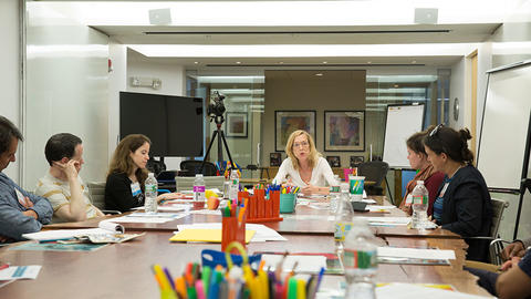 Harvard graduate students sitting in a meeting.