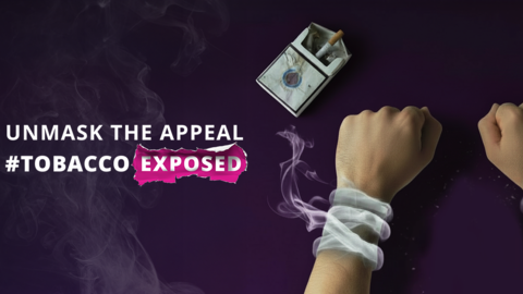 2 hands with smoke around wrists like handcuffs, a pack of cigarettes and an ashtray.
