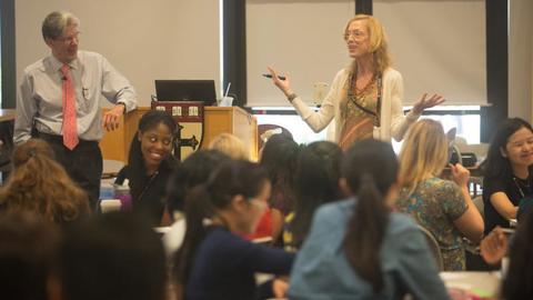 Sue J. Goldie and Julio Frenk standing in front of a group of students.