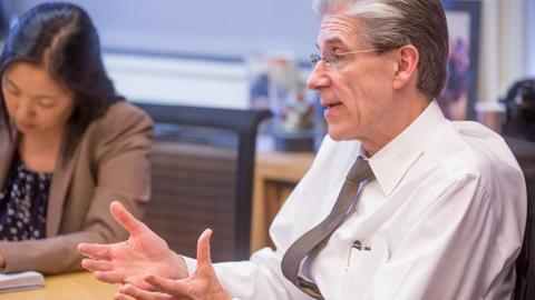 Julio Frenk brainstorming in a meeting.
