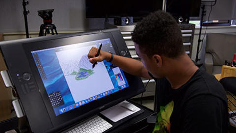 High school student drawing on a computer.