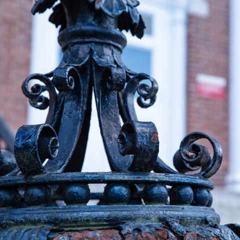 Close-up of ornate iron pole.