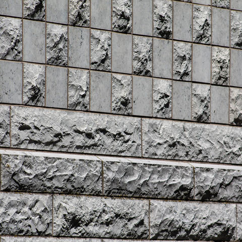 Gray textured wall of Harvard building. 