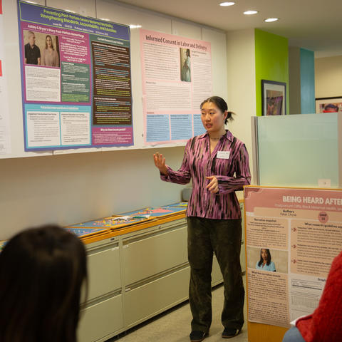 A student from GHHP20 presents their poster in the GHELI space.