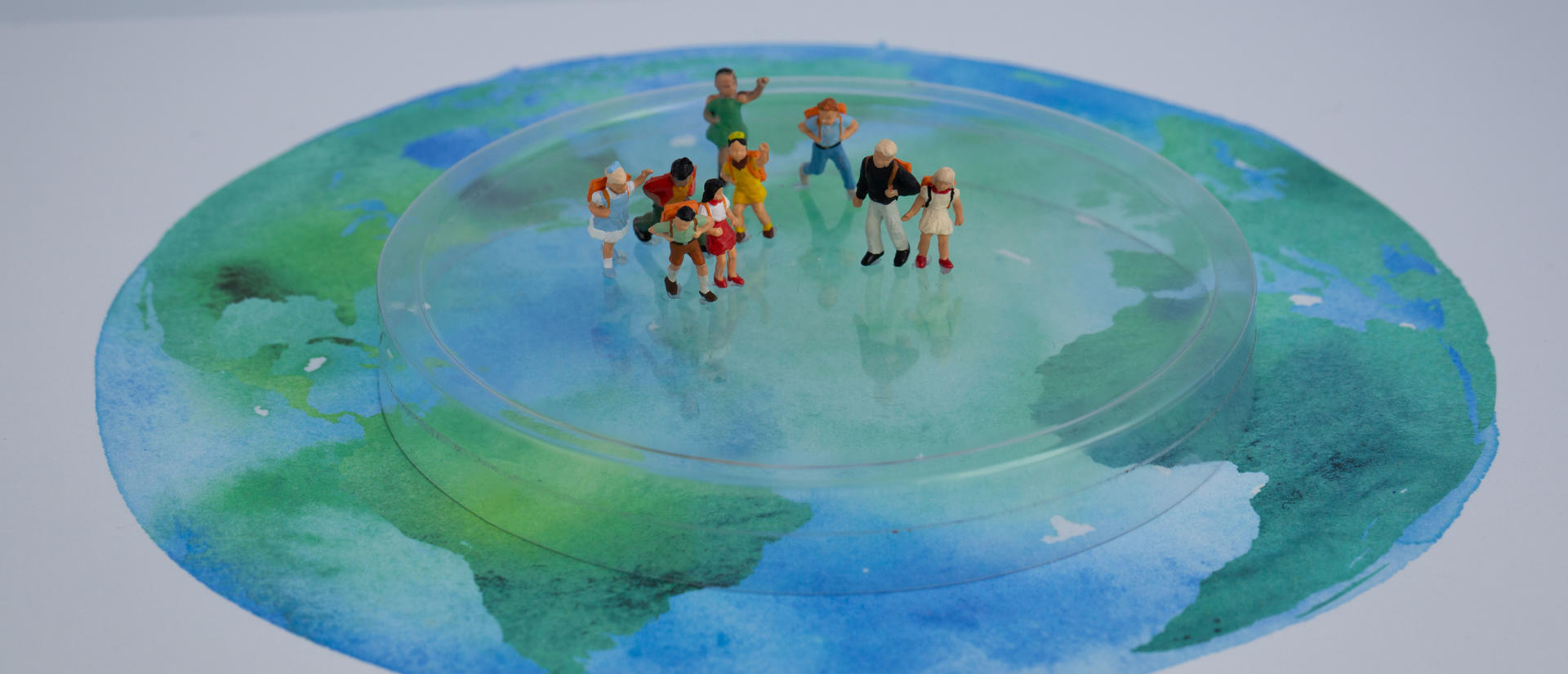 Watercolor globe with people standing on top of it.