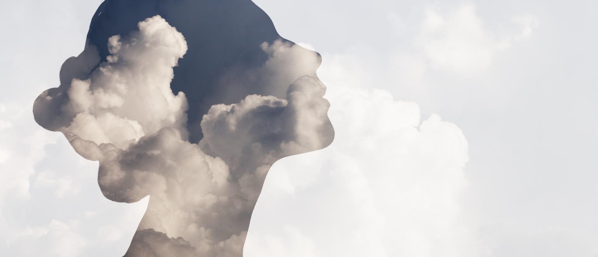 Woman's silhouette overlaid on top of clouds.